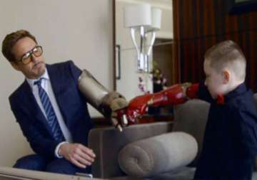 7 yr old jumps with joy as real iron man robert downey jr. gifts him bionic arm