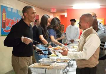 watch video us prez barack obama turns waiter on thanksgiving day