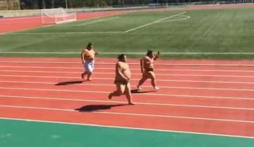 viral video sumo wrestlers sprint down race track in loincloths