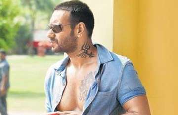 ajay devgn shows off tattoos toned bod