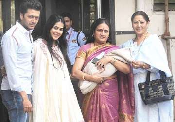 riteish genelia poses with baby outside their house