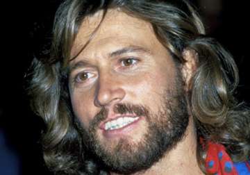 barry gibb left brother s side for granddaughter s birth
