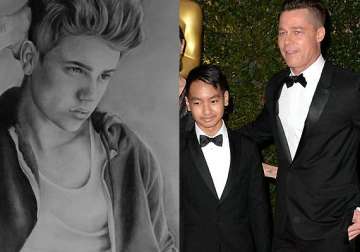 anything for love daddy brad pitt buys justin bieber portrait for son pax