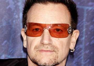 singer bono prays with family on bed