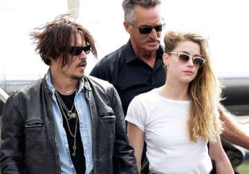 johnny depp s wife amber heard charged with smuggling dogs