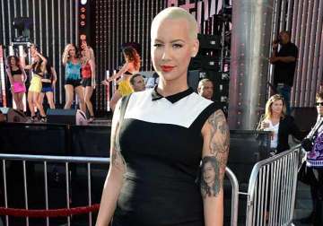 amber rose poses in revealing swimsuit