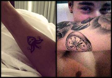 justin bieber flaunts new tattoos see pics