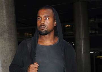 kanye west charged over paparazzo attack