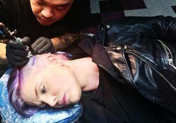 kelly osbourne shocks with tattoo on side of her head