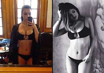 kim kardashian flaunts squeezed assets in a tiny bikini see pics