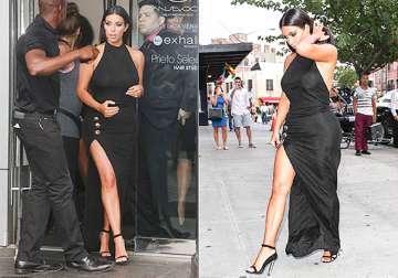 kim kardashian flaunts her toned legs in a sultry black slit dress see pics