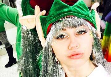 miley cyrus gears up for christmas with full elf costume after surgery see pics