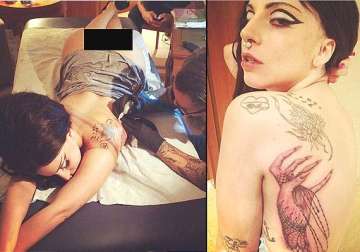 lady gaga bares her derriere while getting inked for the latest tattoo