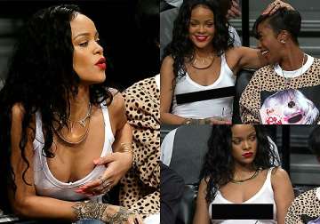 outrageous rihanna goes bra less in a white see through top at basketball match see pics