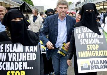 belgian politician campaigns against islam using his daughter wearing bikini inside burqa