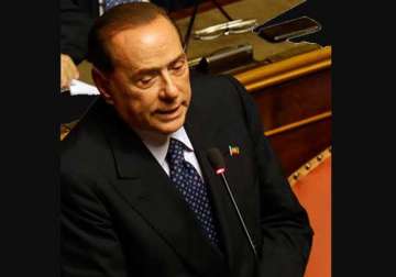 berlusconi defeated decides to back italy government