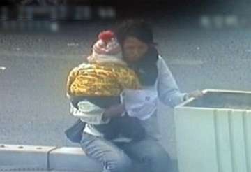 cctv footage of chinese cop saving woman kid trying to jump off bridge