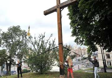 cross chopping topless activist flees ukraine