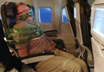 drunken man taped to plane seat by fellow passengers