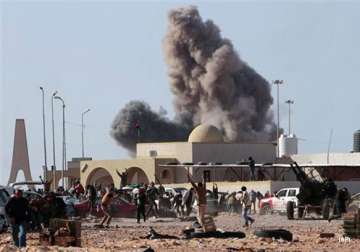 fierce fighting rages in libya gaddafi loyalists block rebels
