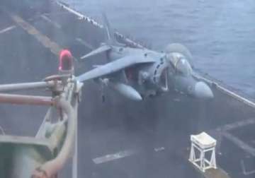fighter pilot lands jet with no front landing gear onto stool aboard a navy ship