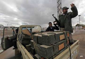 gaddafi supporters blow up arms caches rebels capture oil terminal