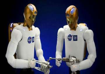 human and humanoid robot shake hands in space