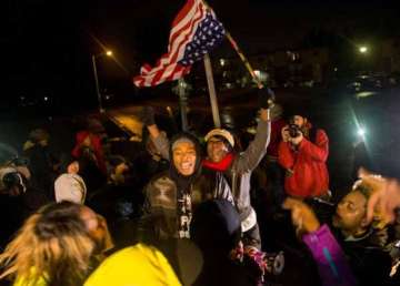 ferguson smoulders as racial protests spread across us