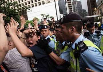 hong kong official warns protesters to face arrest