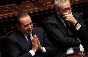 italy s berlusconi wins confidence votes barely