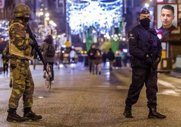 belgian police arrest 16 but paris attacks fugitive still on run