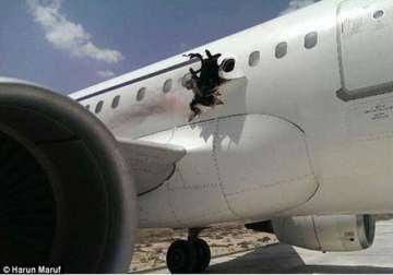 bomb horror man sucked out as explosion forces plane to make emergency landing