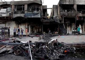 iraqi officials say baghdad market bombings kill 26 people