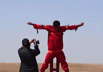 isis video shows jihadist chopping off hand foot of a man