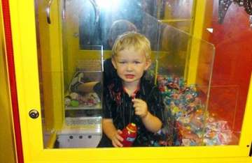 australian toddler trapped inside lolly machine while trying to grab sweets