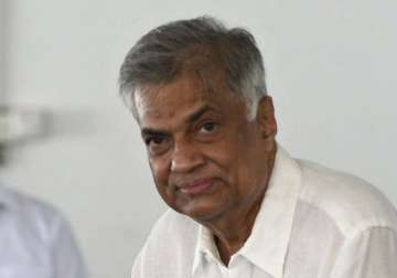 sri lanka s prime minister sworn in as 2 parties sign deal