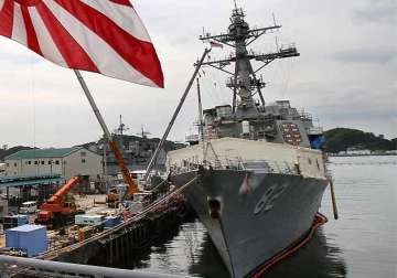 china warns us navy after ship sails by chinese built island