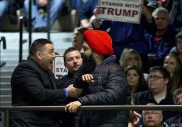 watch sikh protestor with stop hate sign thrown out of donald trump s rally