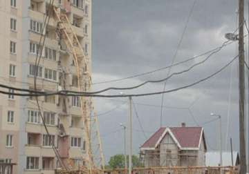 large crane collapses on apartment building in russia