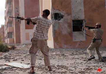 libyan fighters assault main gadhafi base in sirte