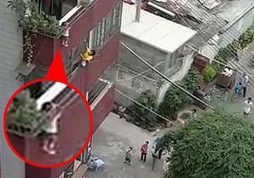 neighbours rescue boy dangling by the head from window