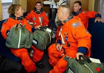 shuttle astronauts busy with space station stockpiling