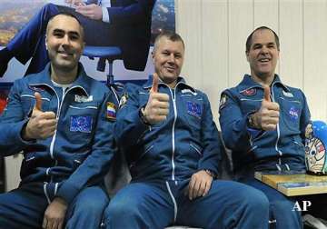 three astronauts return to earth from space station