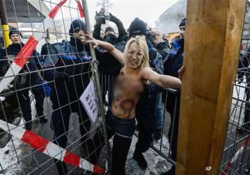 three ukrainian women stage topless protest in davos