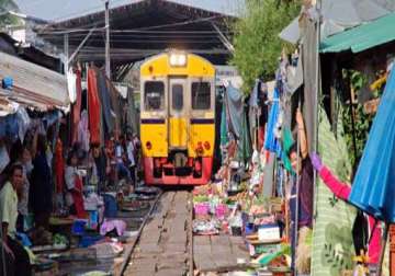 watch in pics bizarre market in vietnam where train runs through narrow streets