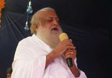 asaram bapu throws prasad at devotee hits him in the eye case lodged