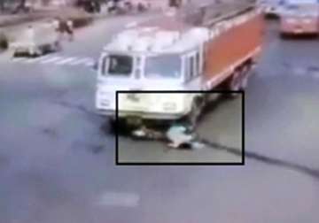 caught on camera woman escapes after speeding truck crushes her bike