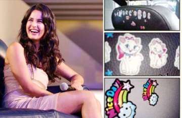 katrina decorates her car seat with her favourite cartoons