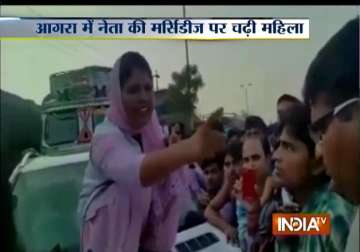 agra woman breaks windshield of sp leader s car after his gunner winks at her