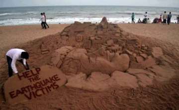 sand artist s message for helping earthquake victims